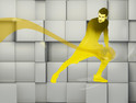 A man spreads yellow oil over a gray background