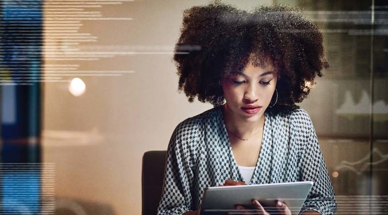 A woman works at a tablet