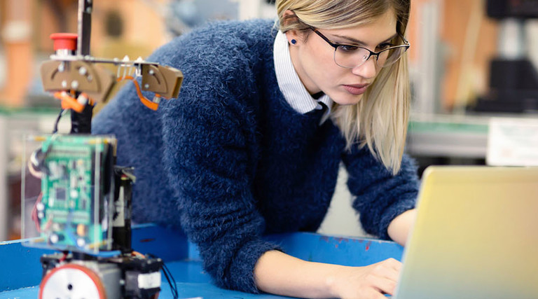Young woman engineer working on robotics project