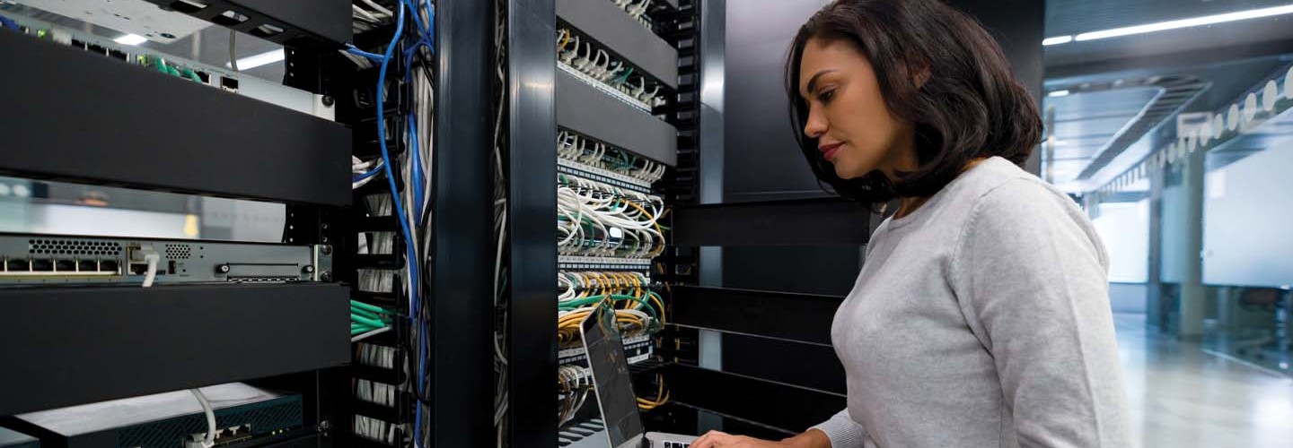An IT worker looks at a server