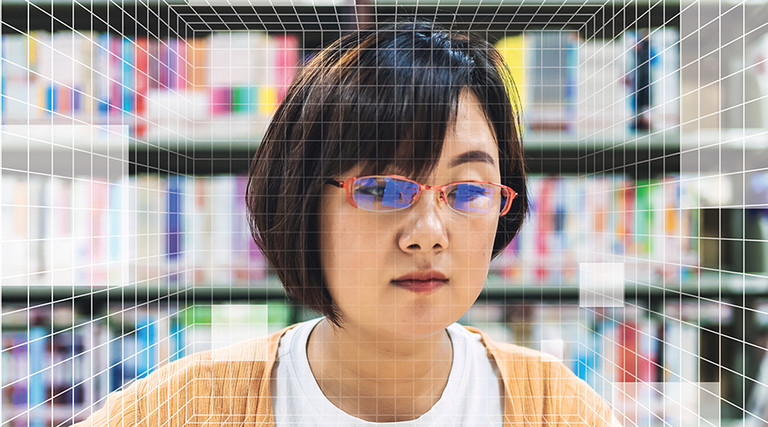A woman's face behind a grid