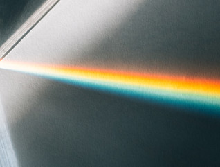 A beam of light shines through a prism