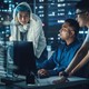 A team of cybersecurity staffers look at a screen