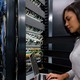 An IT worker looks at a server
