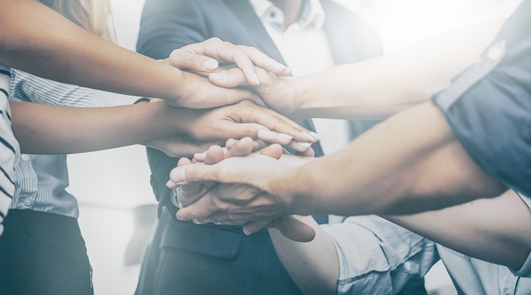 Team puts hands in