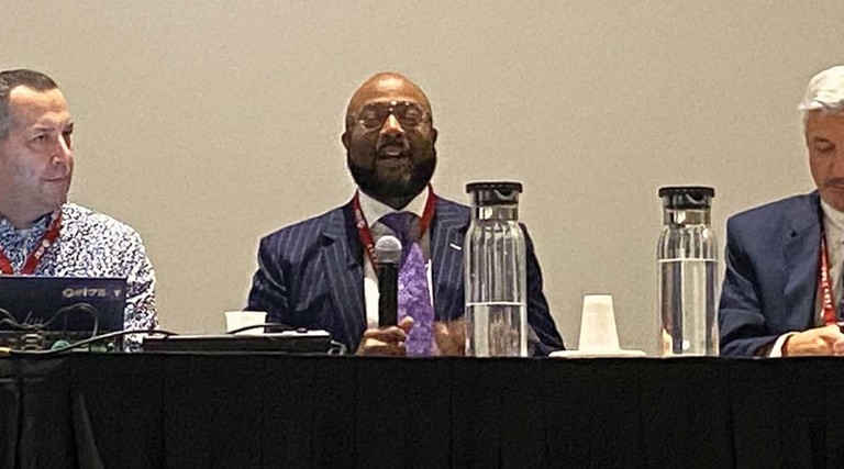 Three panelists address the crowd at EDUCAUSE 2022