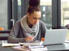 A woman works at her laptop
