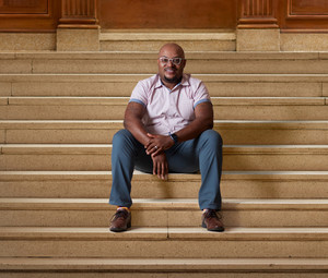 Curtis Cain sits on the steps of a building at Howard University