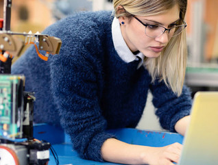 Young woman engineer working on robotics project