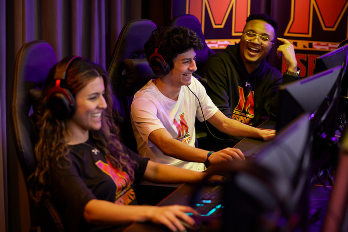 Sergio Brack and two University of Maryland students in an esports arena