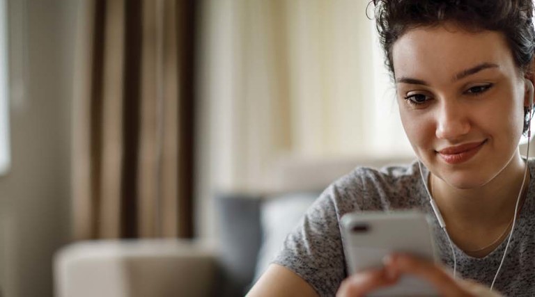 A college student looks at her cell phone.