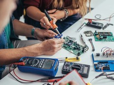Students work on a microchip board