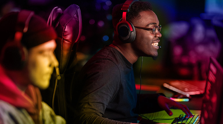 Two gamers play in an esports arena