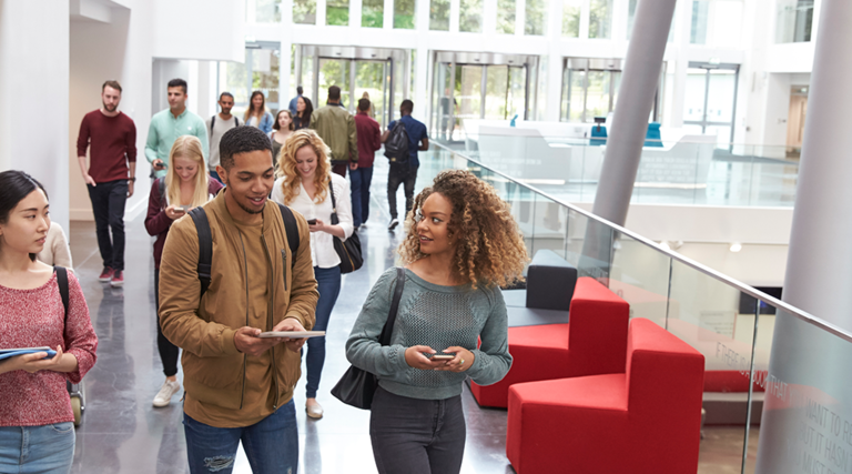 Students walking with mobile tech