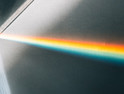 A beam of light shines through a prism