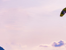 A person parachutes through the sky
