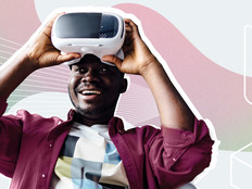 A man lifts a virtual reality headset off his eyes