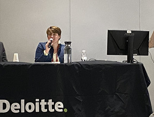 Panelists speaking at a conference