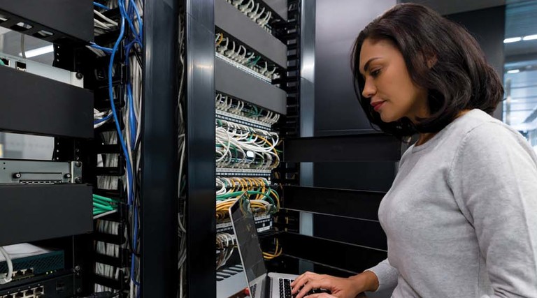 An IT worker looks at a server