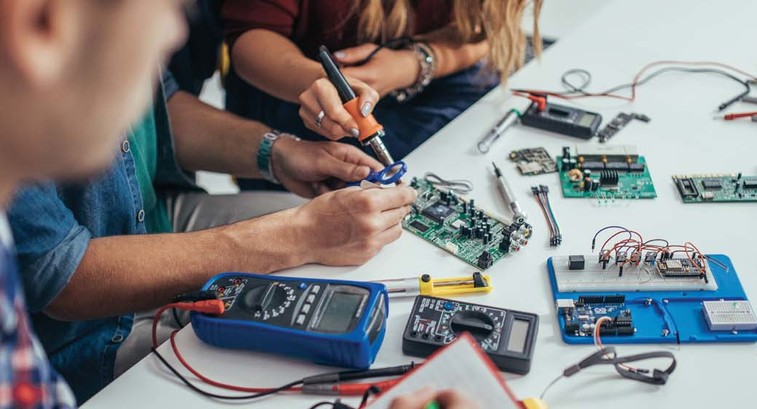 Students work on a microchip board