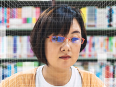A woman's face behind a grid