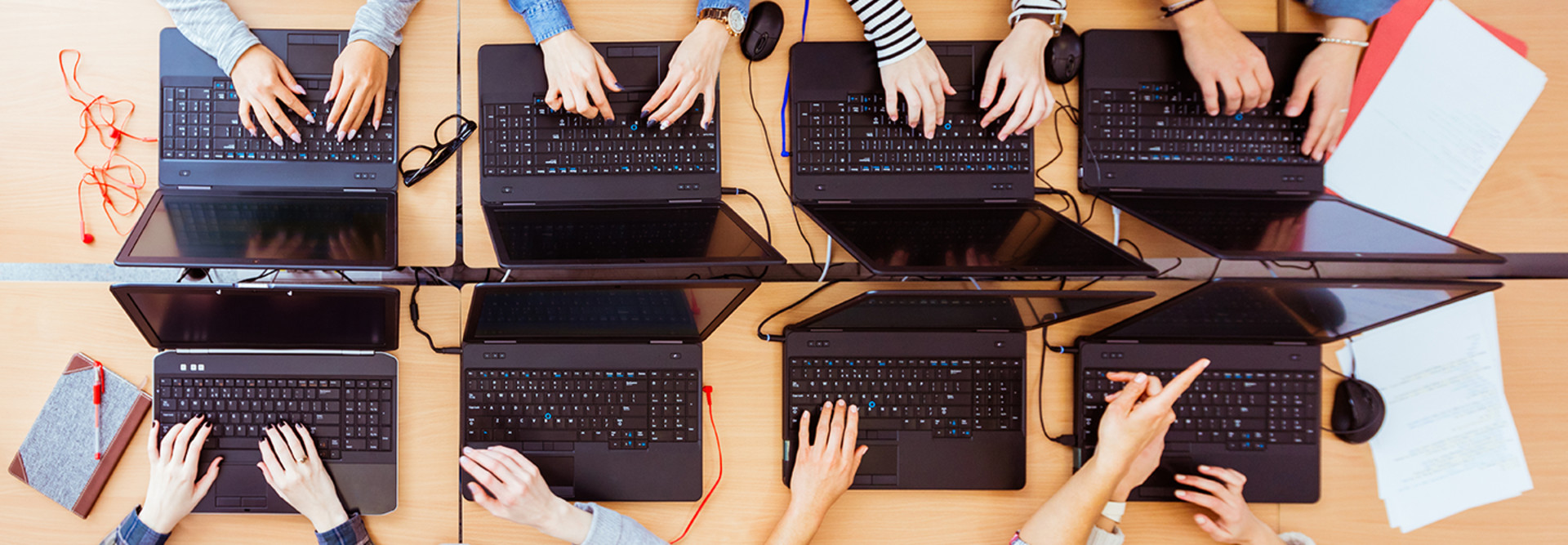 Hands working on computers