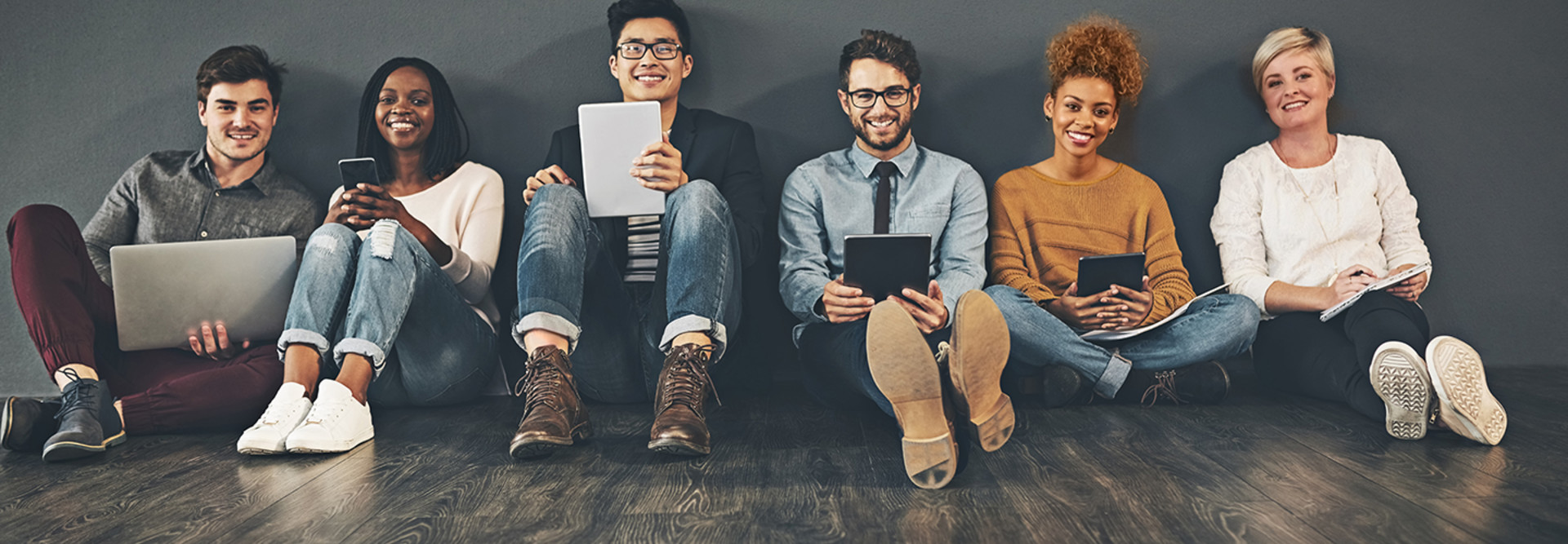 Students using tech in a row