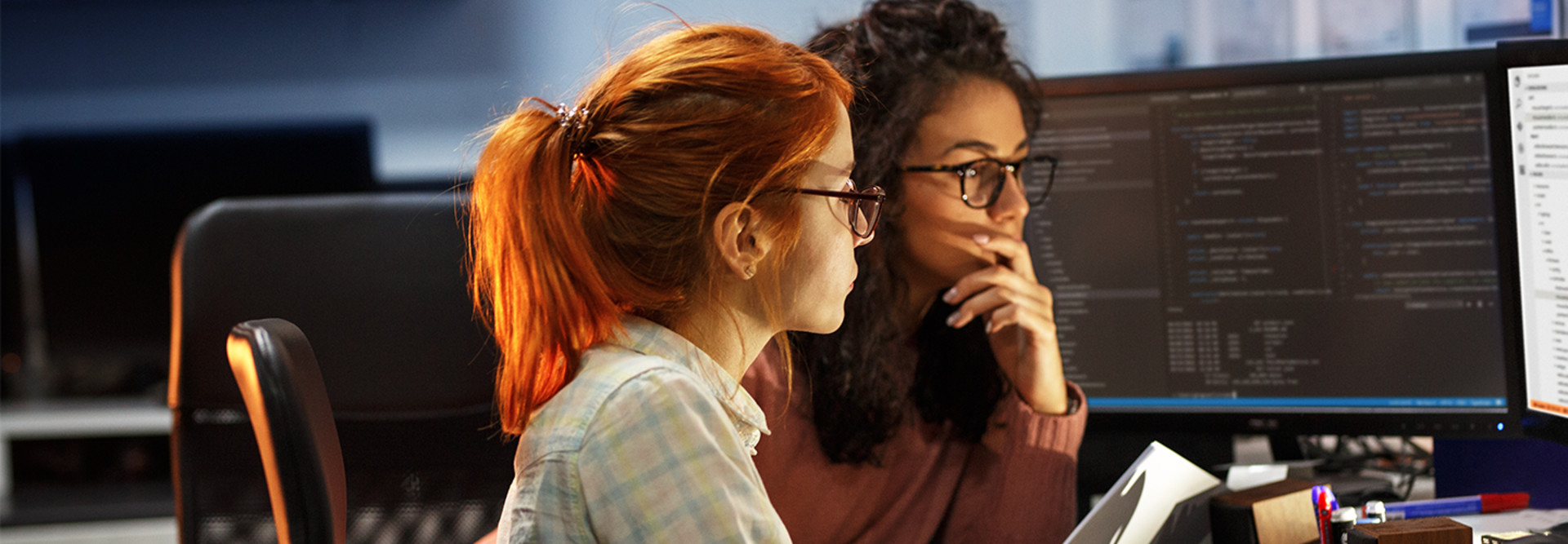 Two women staring at a computer