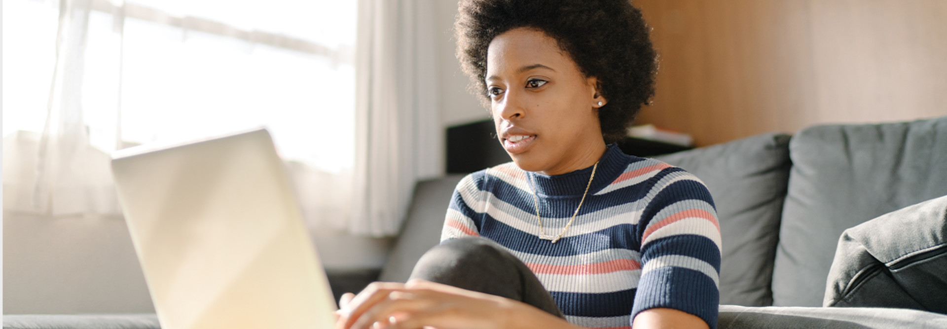 young woman using laptop at home