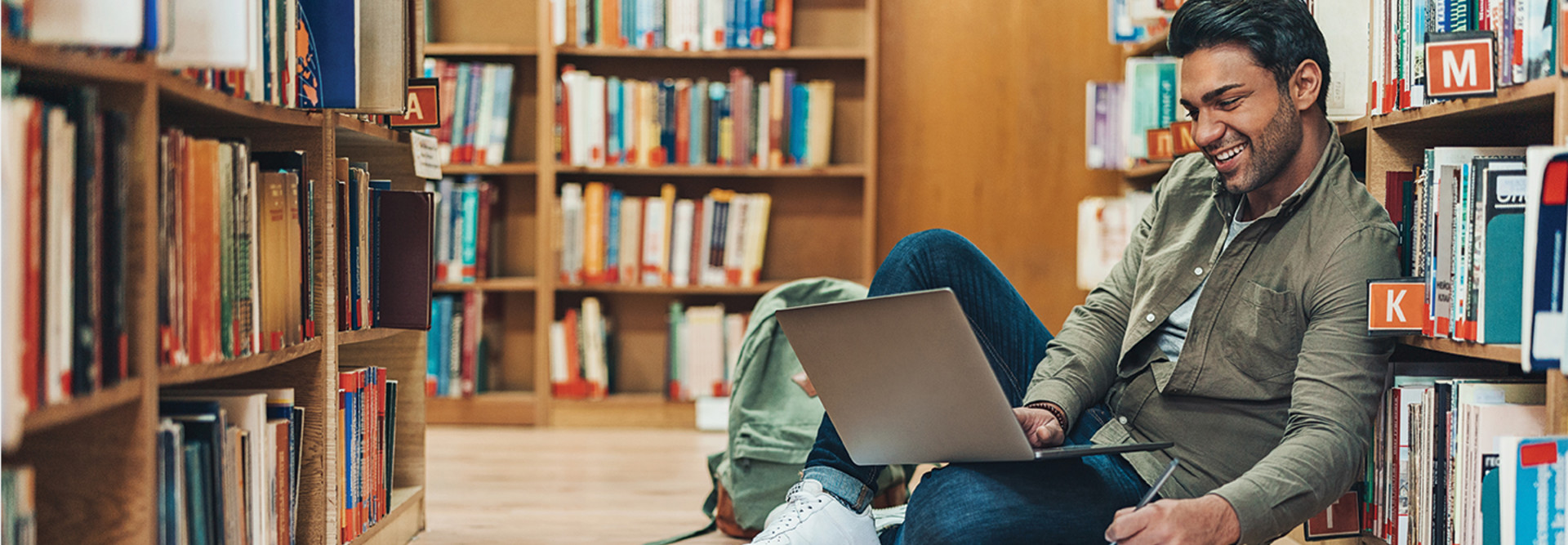 Student in library using laptop