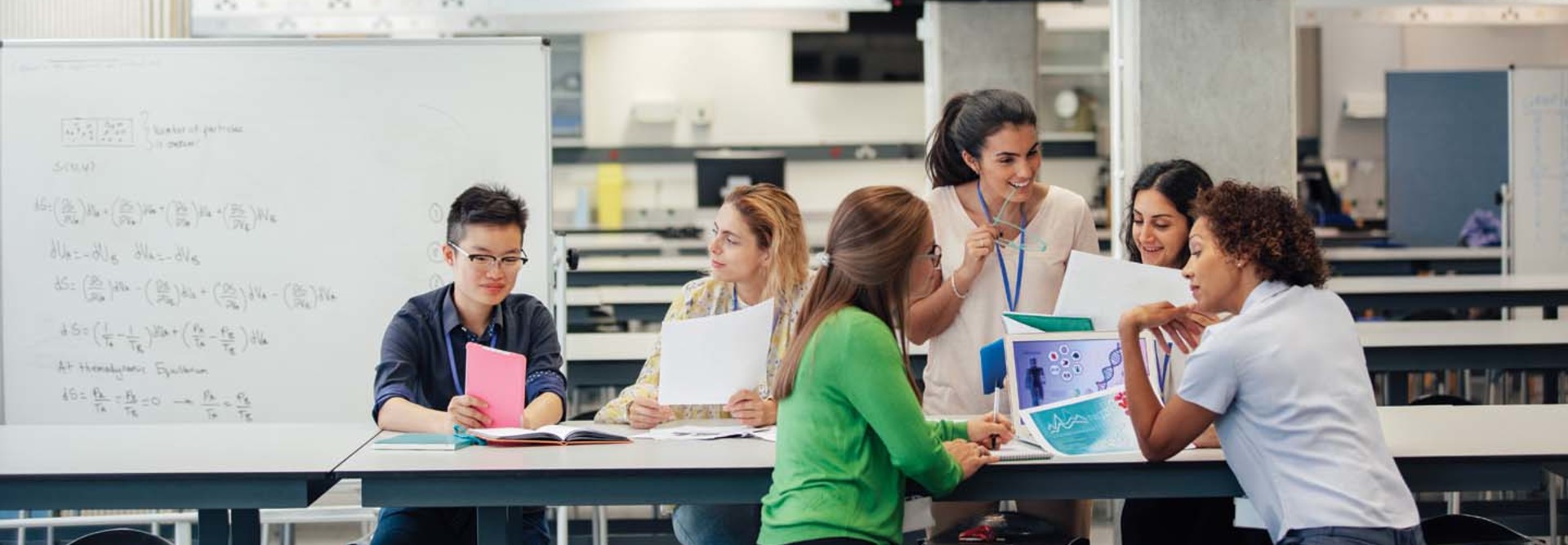 A group of women in a higher ed learning environment