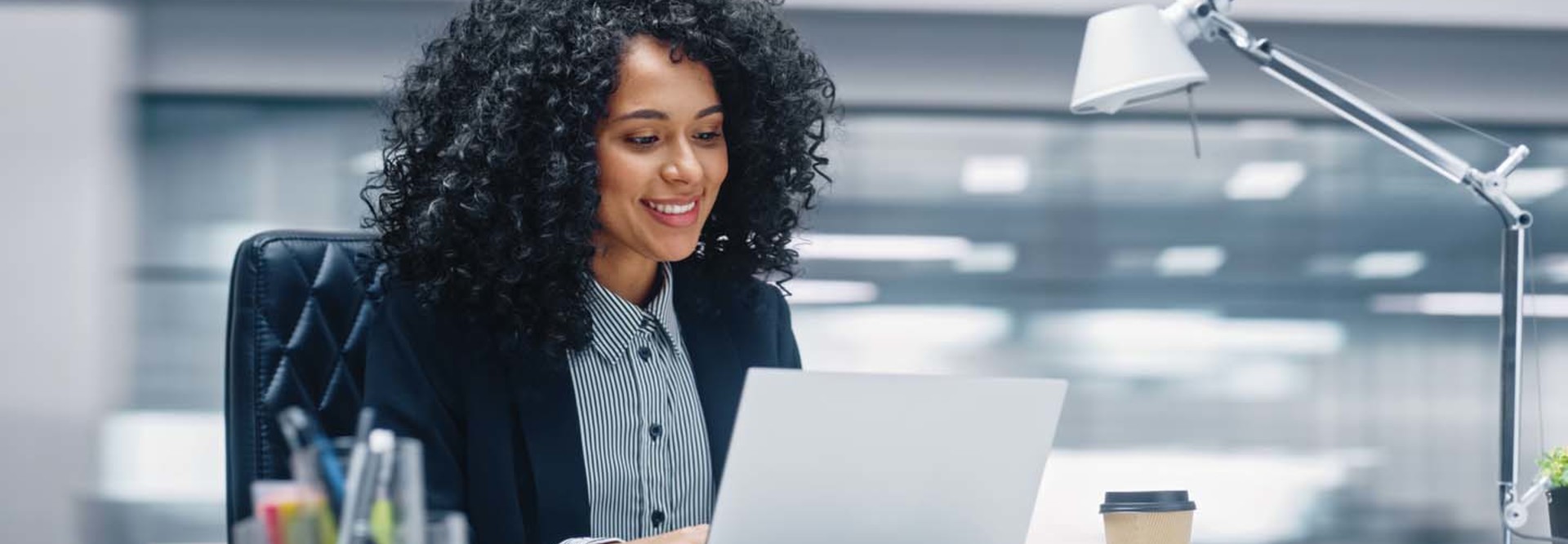 A woman works at her computer