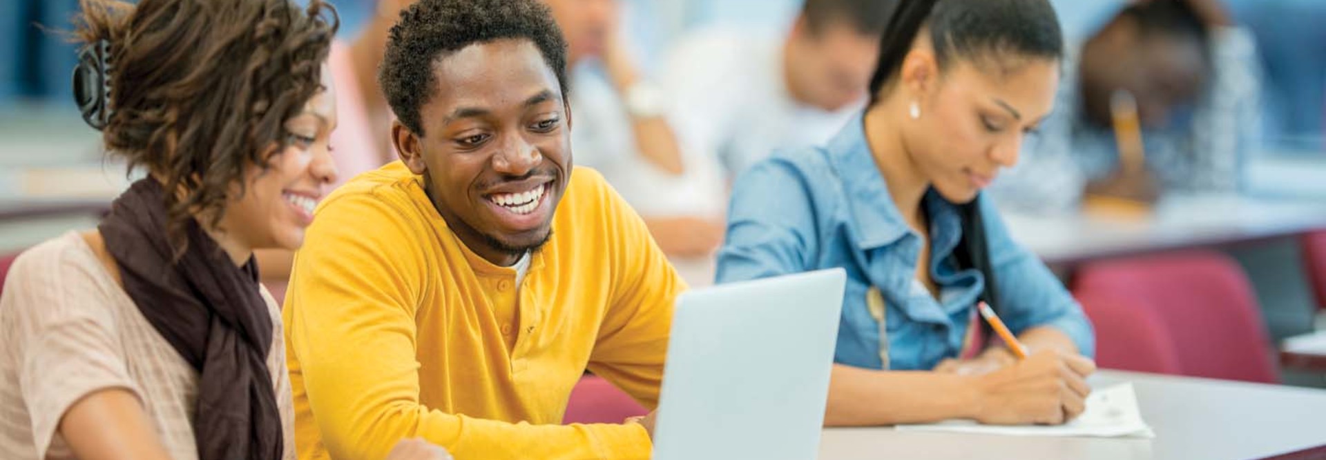 Students work at a laptop