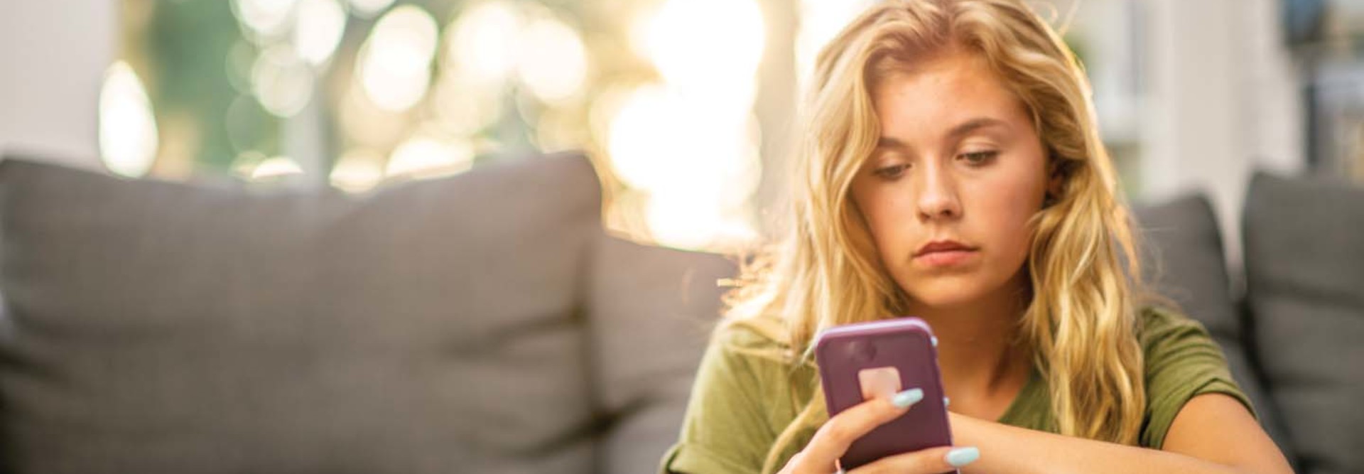 A woman looks at her cell phone