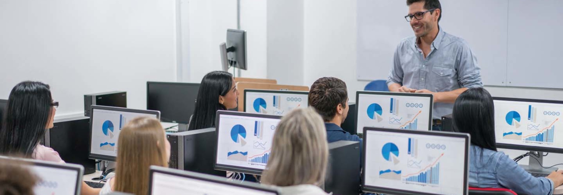 A professor leads a room on students on their devices