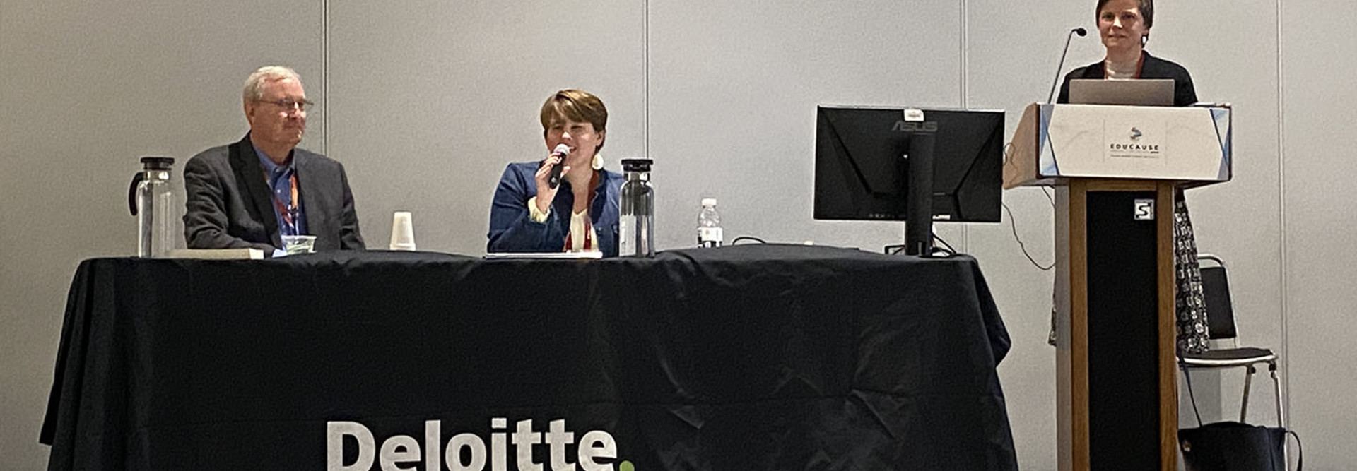 Panelists speaking at a conference