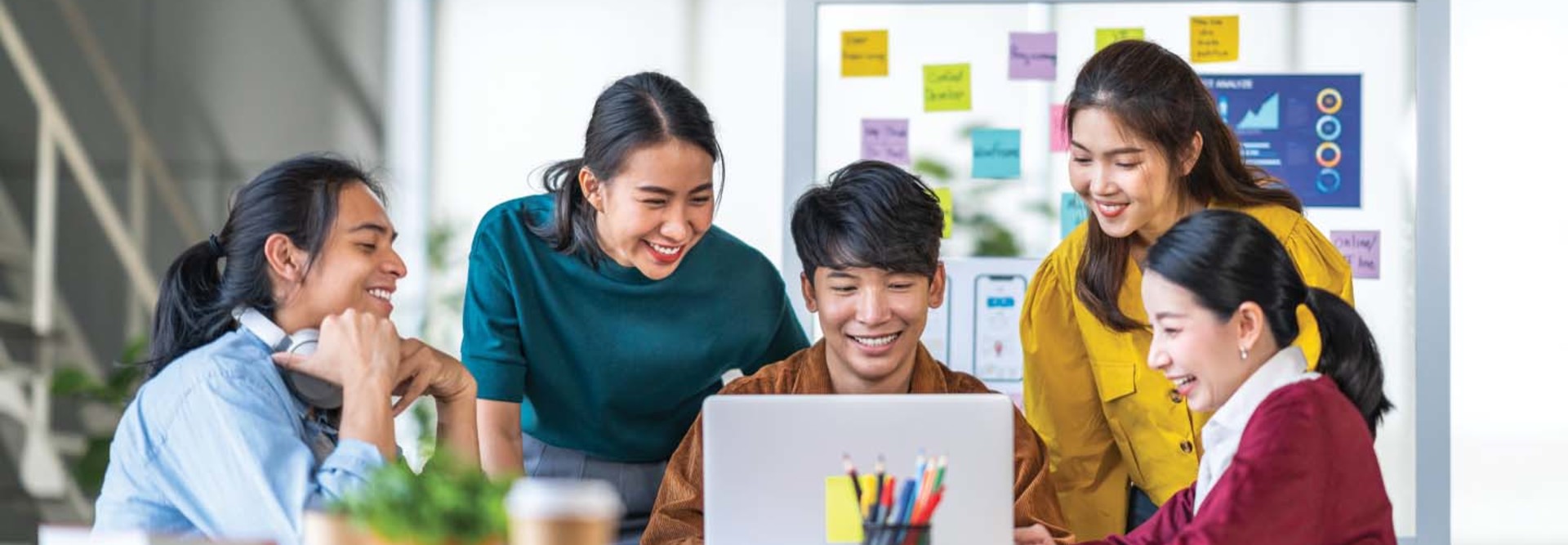 Students gather around a laptop