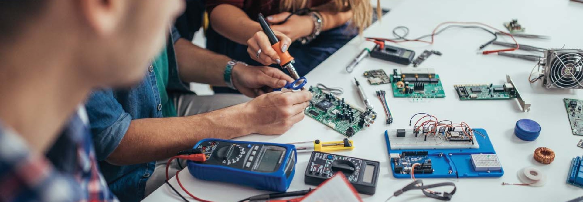 Students work on a microchip board