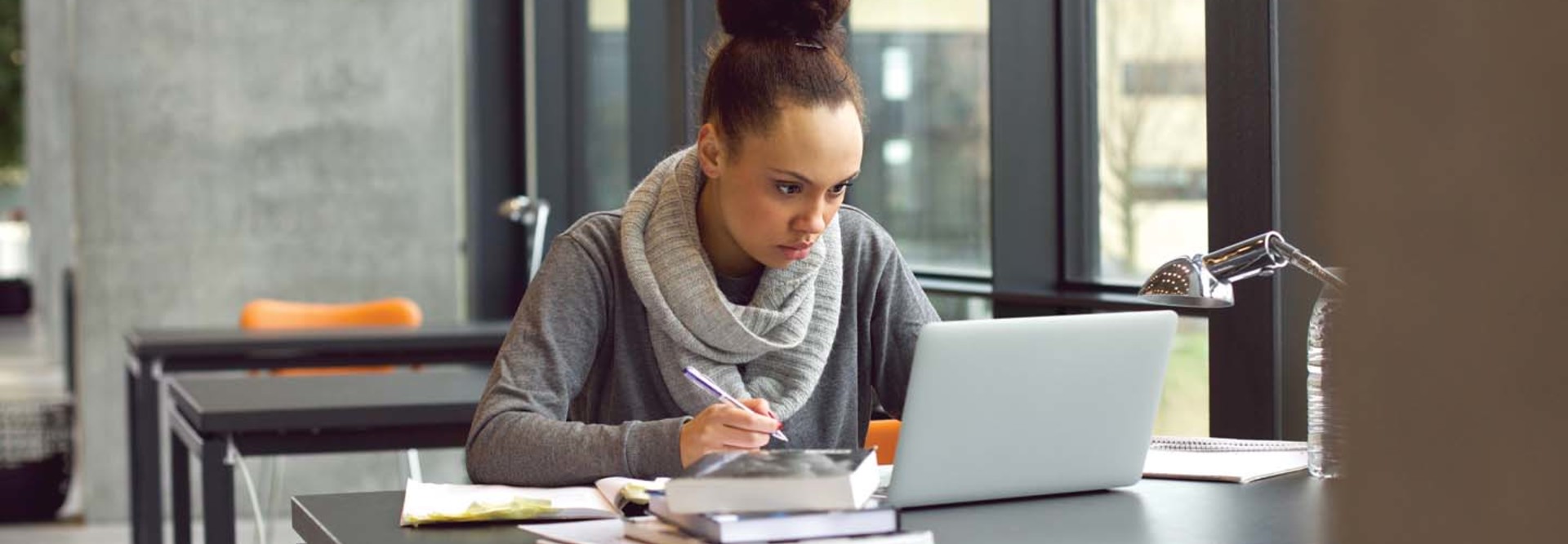 A woman works at her laptop
