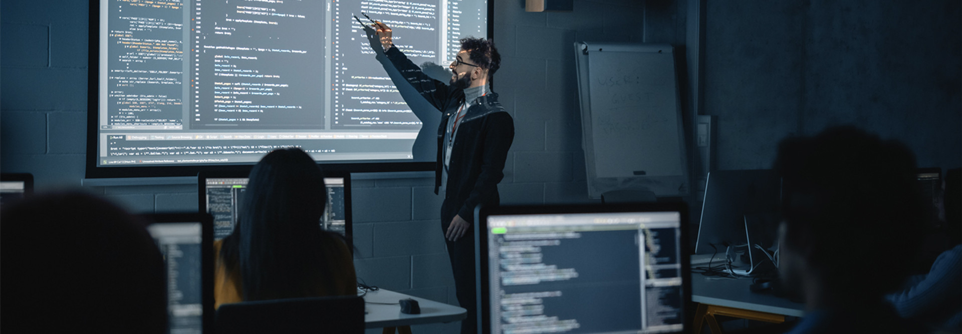 Instructor explaining programing to students