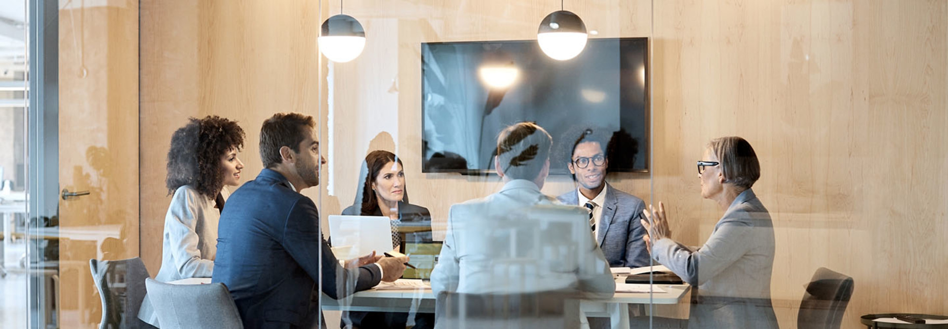 People meeting formally in a boardroom