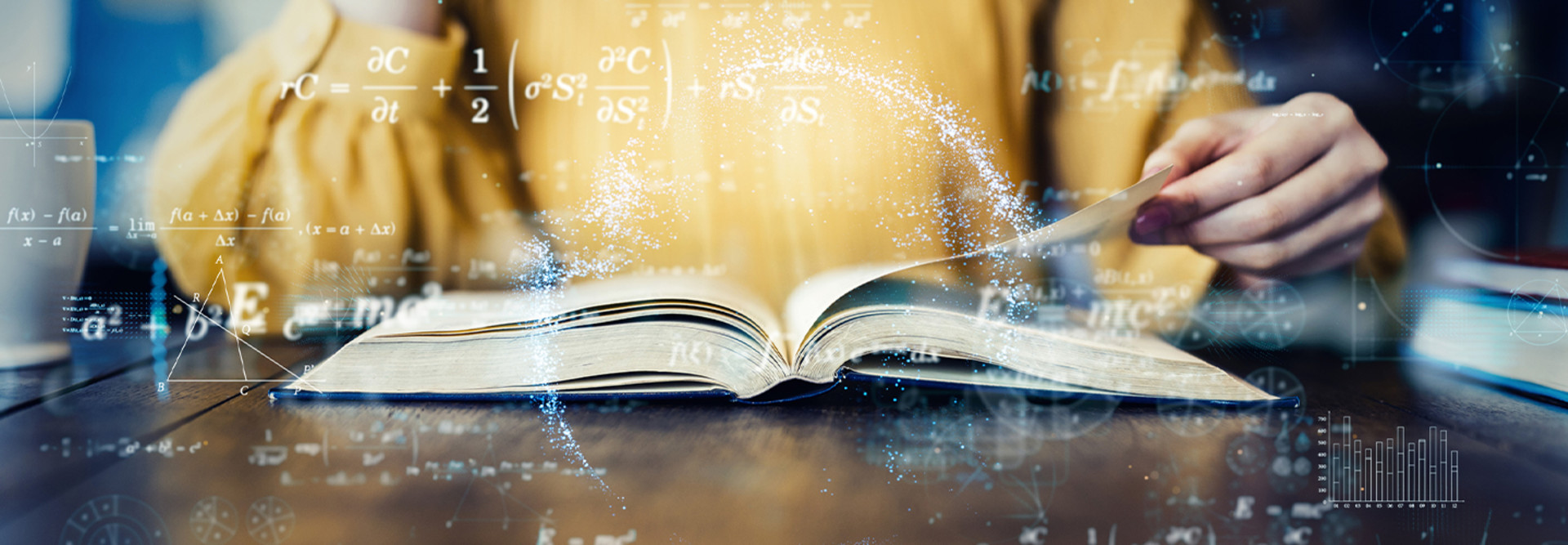 A woman flips through a textbook