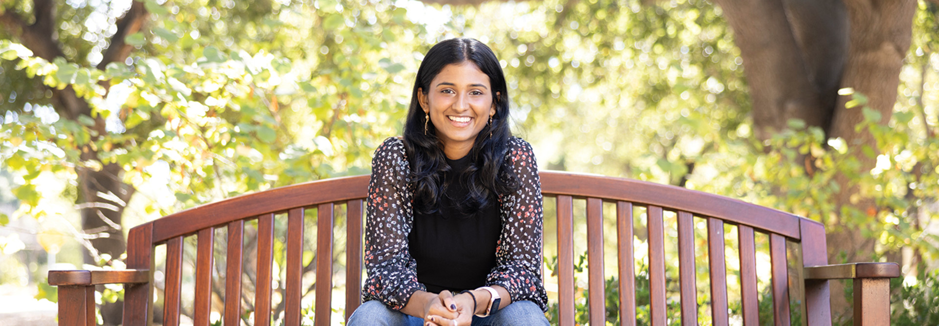 Kyla Guru seated on a bench