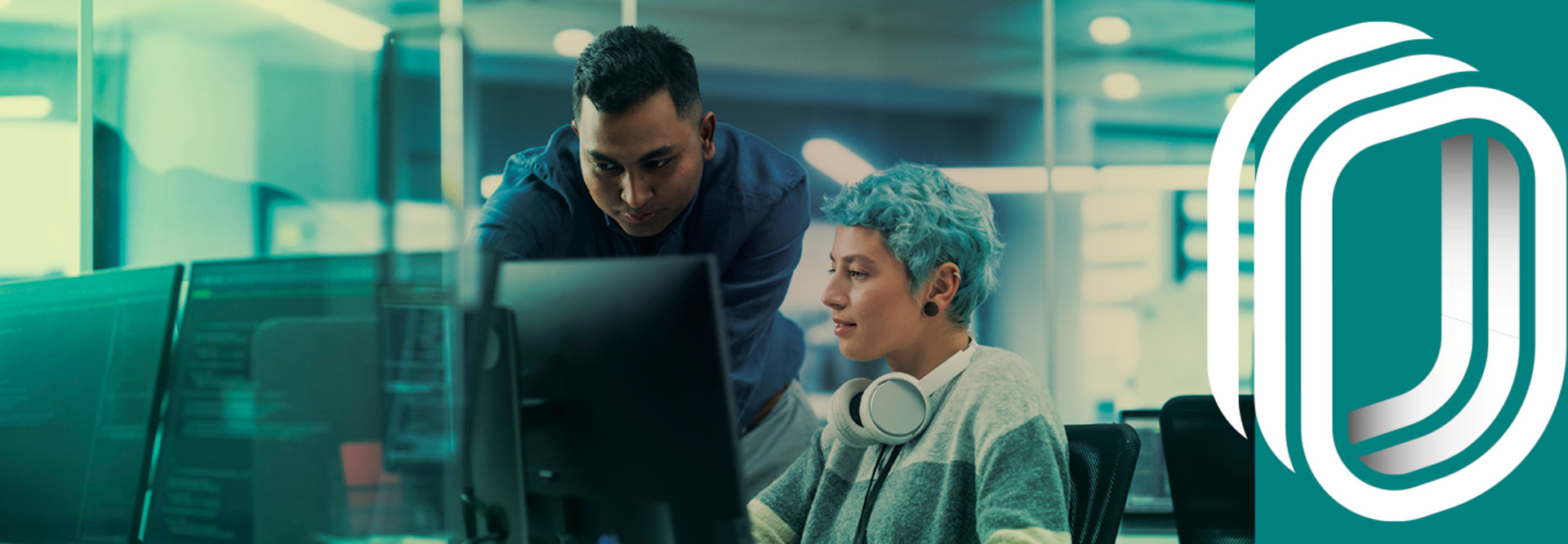 teacher and student viewing computer monitor