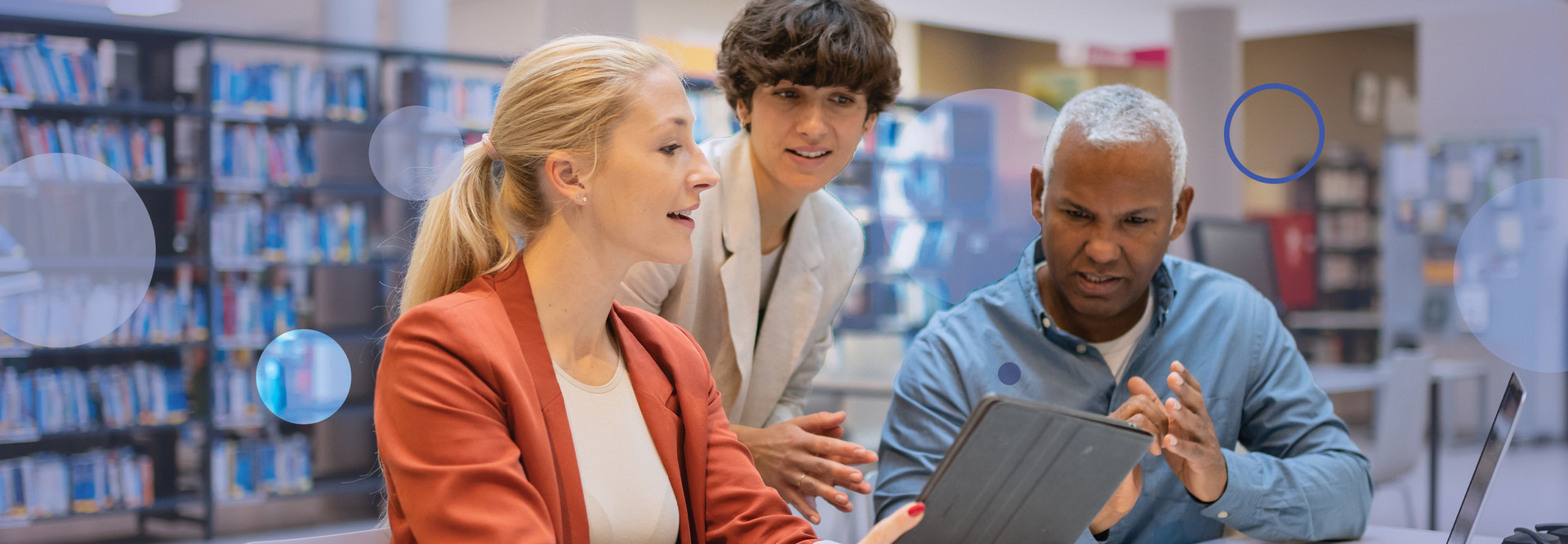 Three people gather around a device