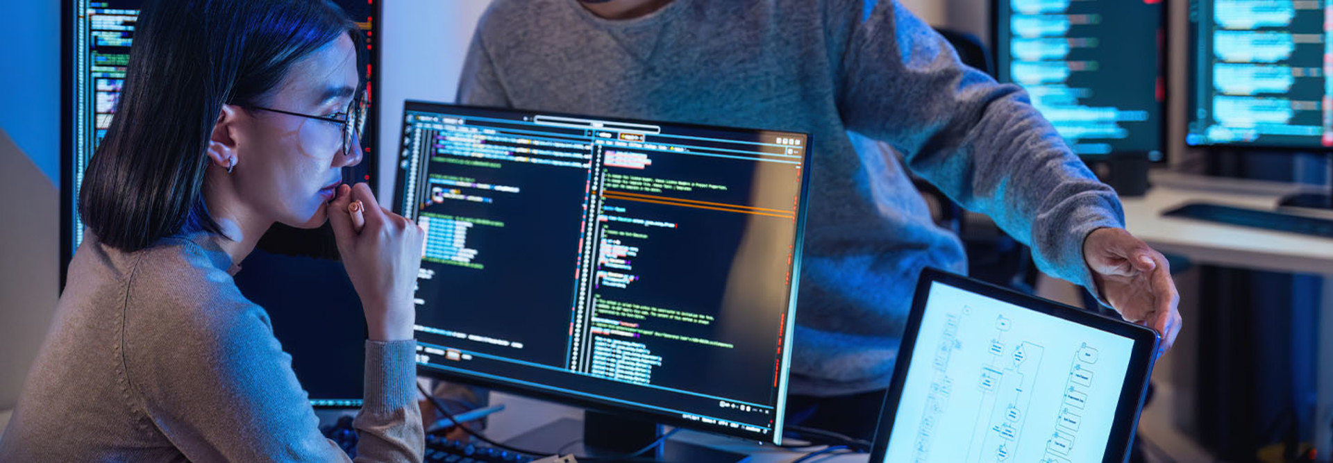 People working on code in the office