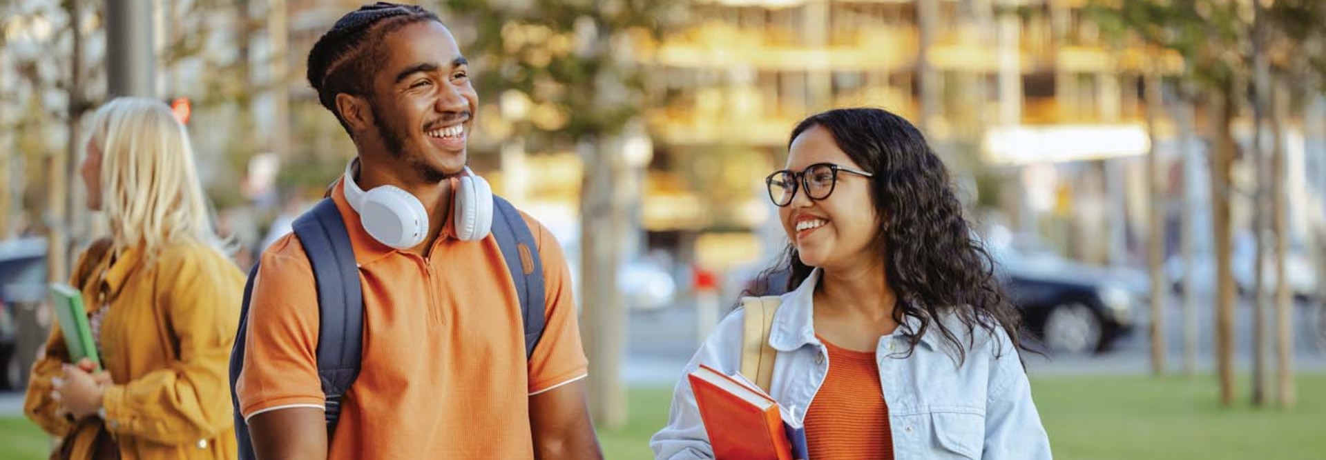 Two college students chat on an outdoor walk