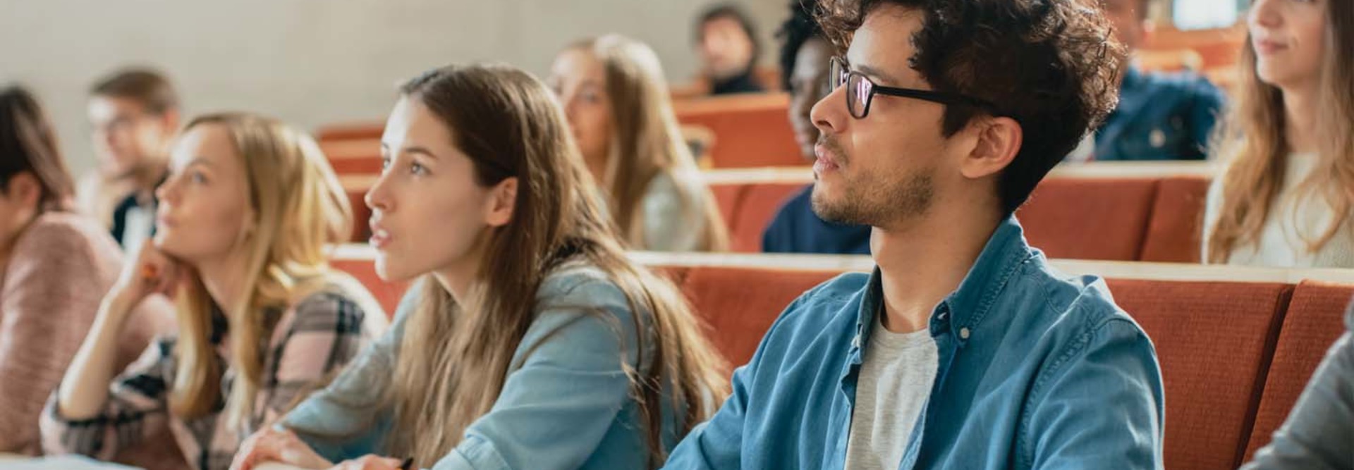 Students in a lecture hall listen intently