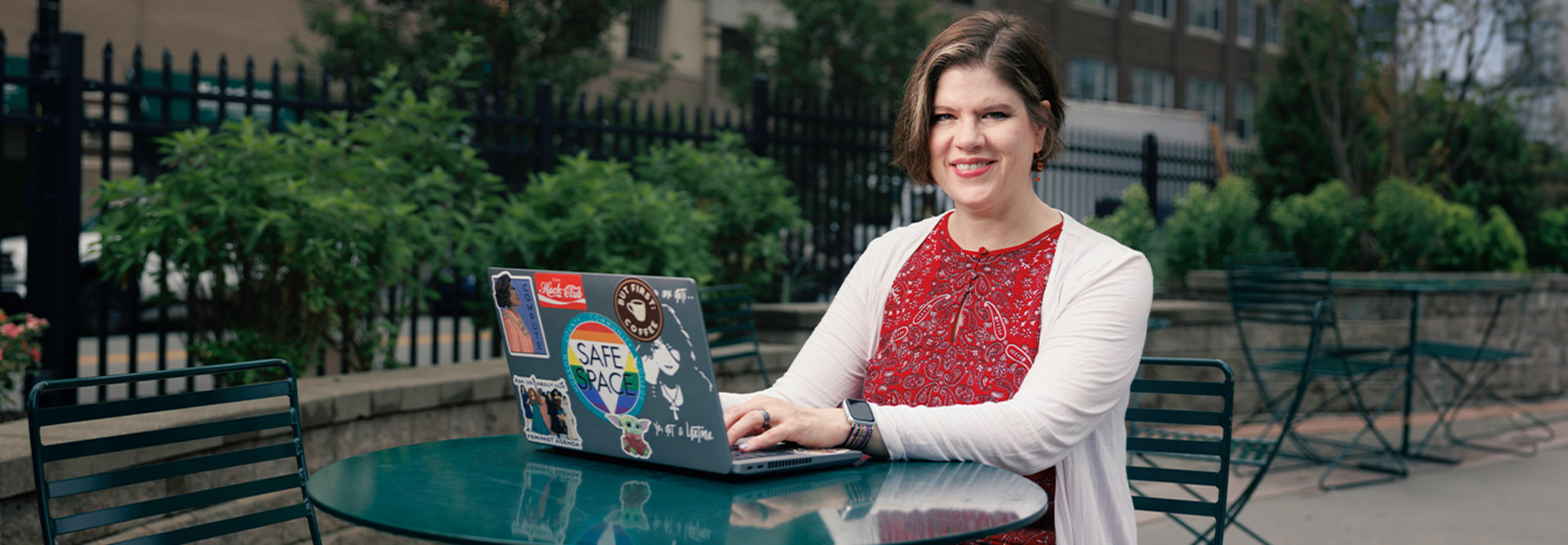 Patricia Clay uses her desktop at an outdoor table