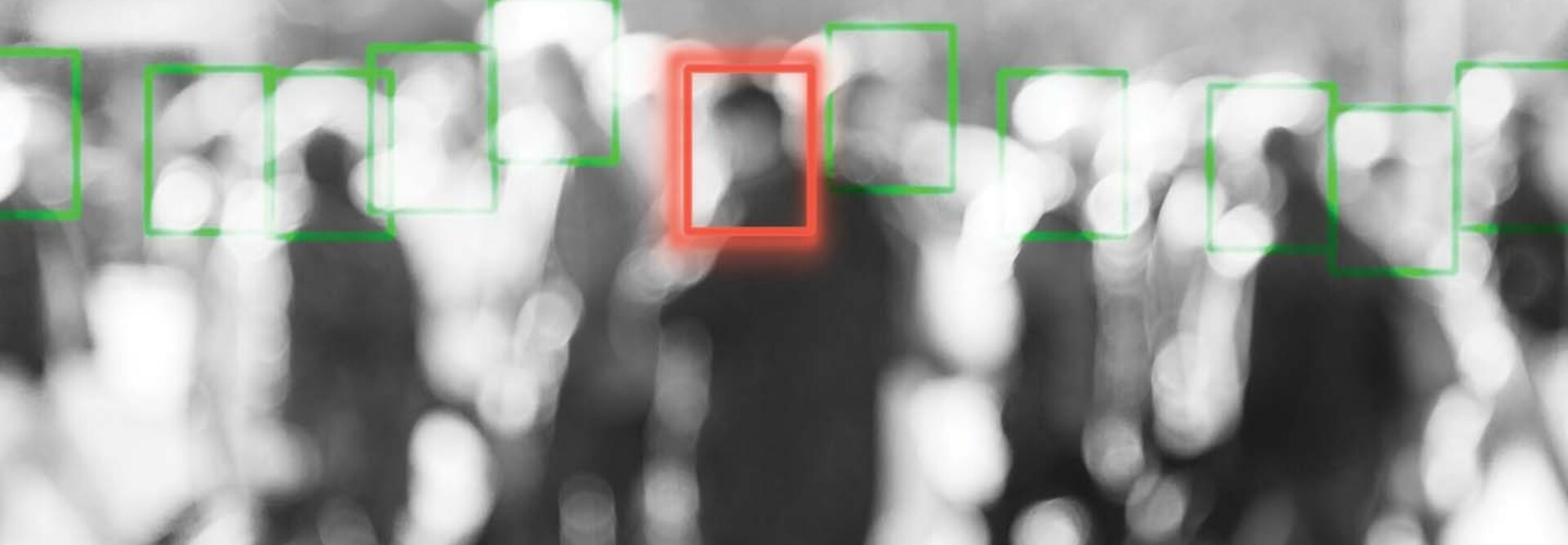 A blurred crowd of people whose faces are being scanned by an unseen camera
